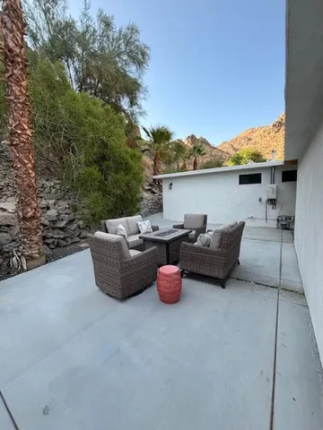 a view of a chairs and table in the patio