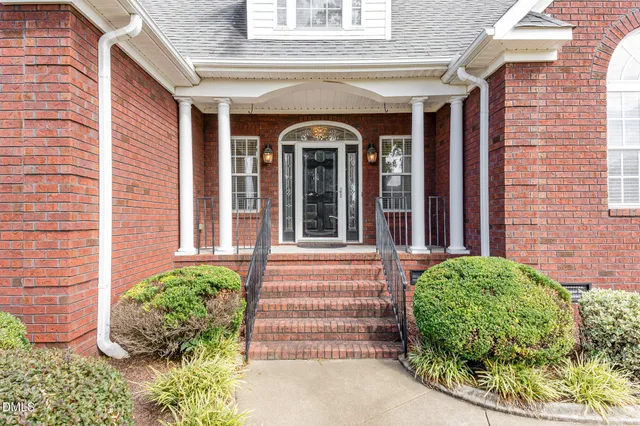 a view of a brick house with potted plants