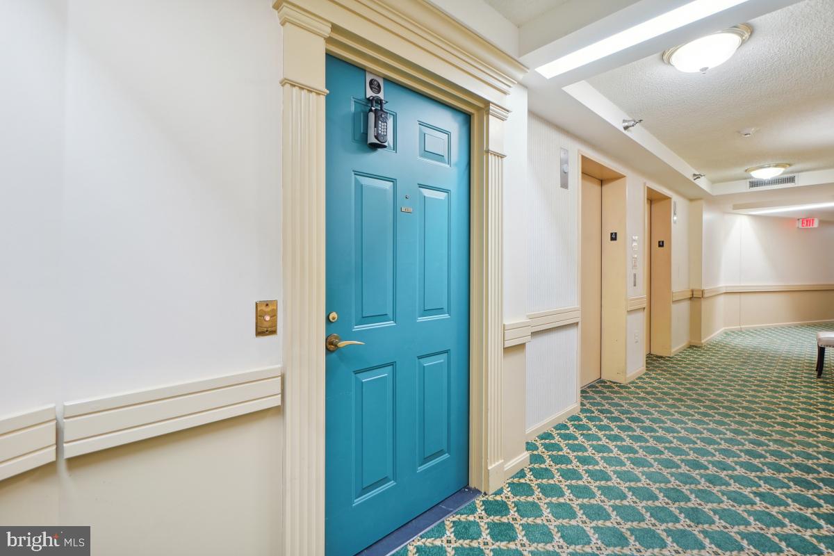 14801 Pennfield Circle, Unit 401 Silver Spring, MD 20906 - Photo 2 of 31 a bedroom with a bed and a table