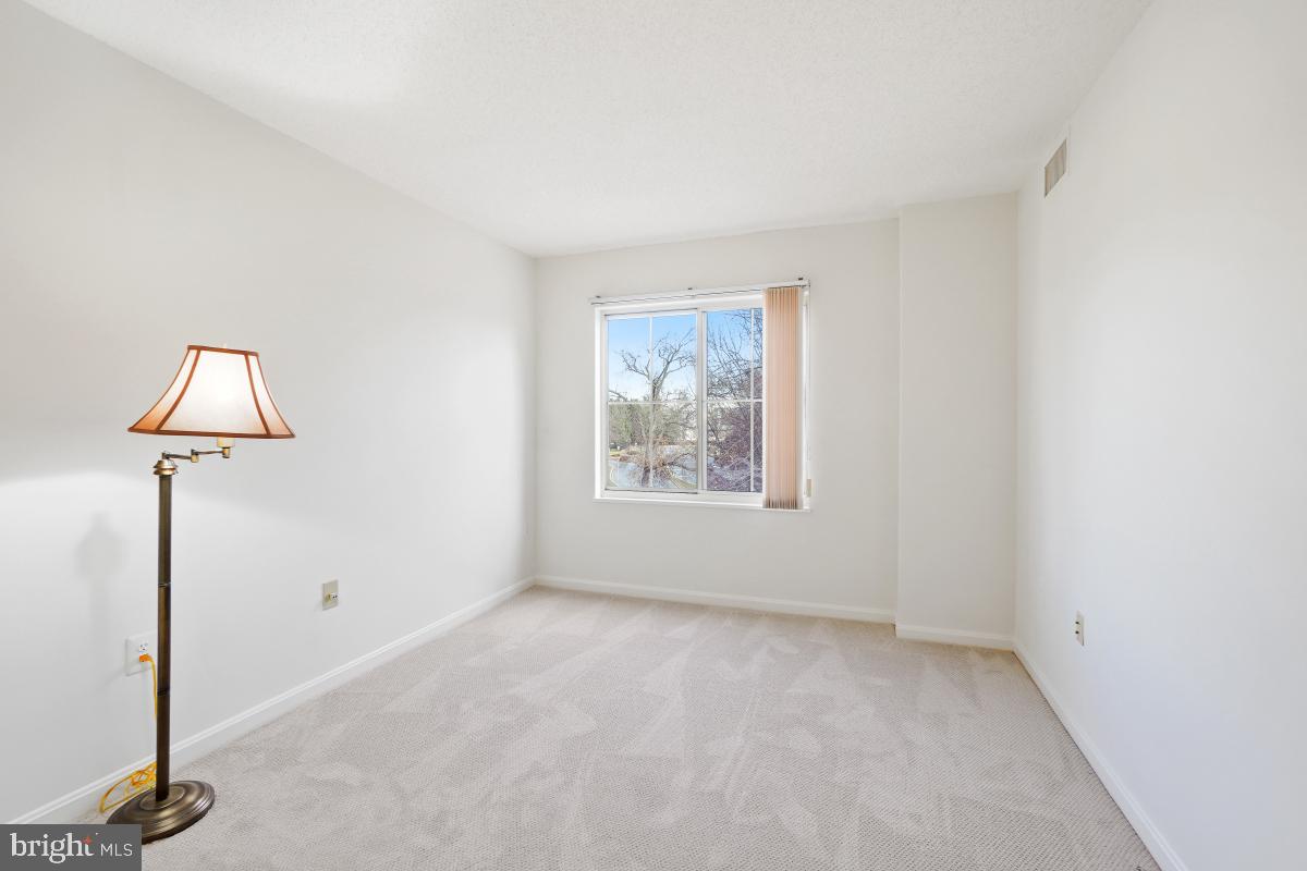 14801 Pennfield Circle, Unit 401 Silver Spring, MD 20906 - Photo 23 of 31 a view of an empty room with a window