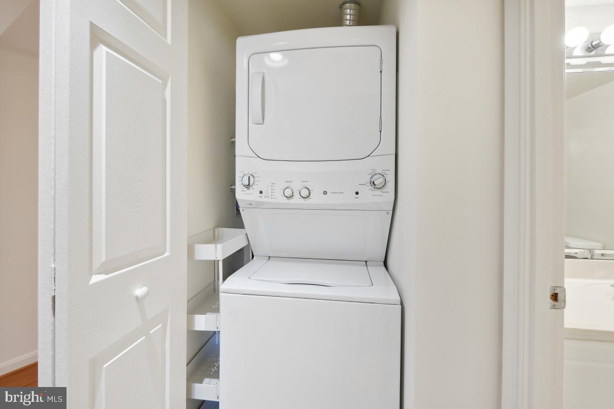 14801 Pennfield Circle, Unit 401 Silver Spring, MD 20906 - Photo 27 of 31 a utility room with dryer and washer