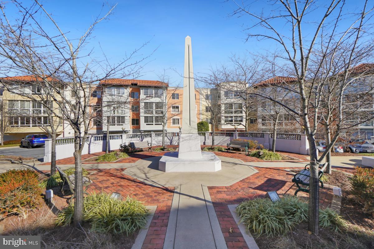14801 Pennfield Circle, Unit 401 Silver Spring, MD 20906 - Photo 30 of 31 a view of a patio with table and chairs and potted plants