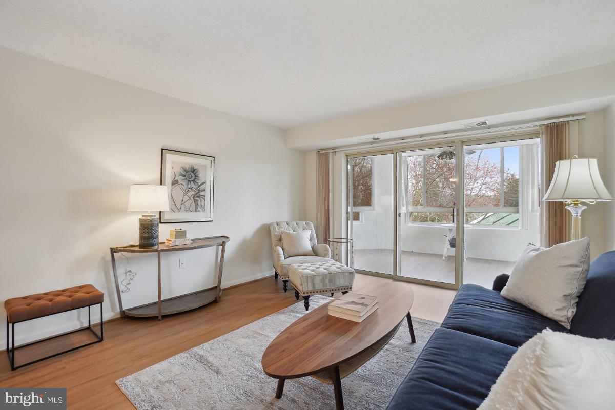 14801 Pennfield Circle, Unit 401 Silver Spring, MD 20906 - Photo 5 of 31 a living room with furniture and a window