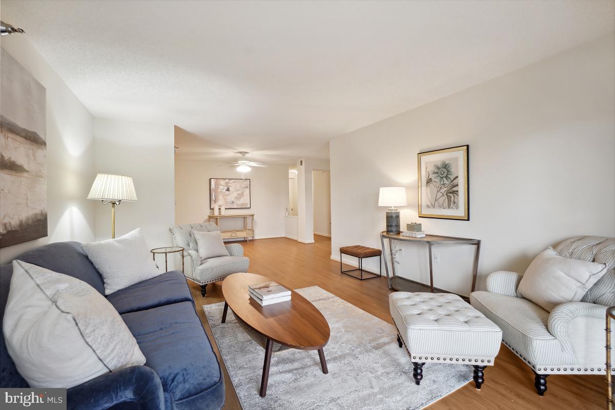 14801 Pennfield Circle, Unit 401 Silver Spring, MD 20906 - Photo 6 of 31 a living room with furniture and a wooden floor