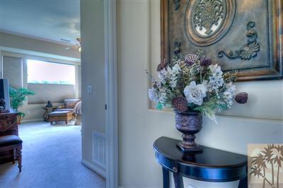 81249 Red Rock Road La Quinta, CA 92253 - Photo 18 of 25 a vase of flowers sitting on a table with a fireplace