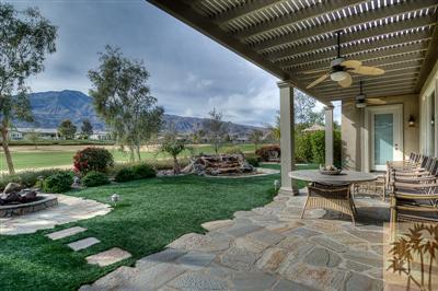 81249 Red Rock Road La Quinta, CA 92253 - Photo 3 of 25 a view of a patio with couches chairs and a big yard