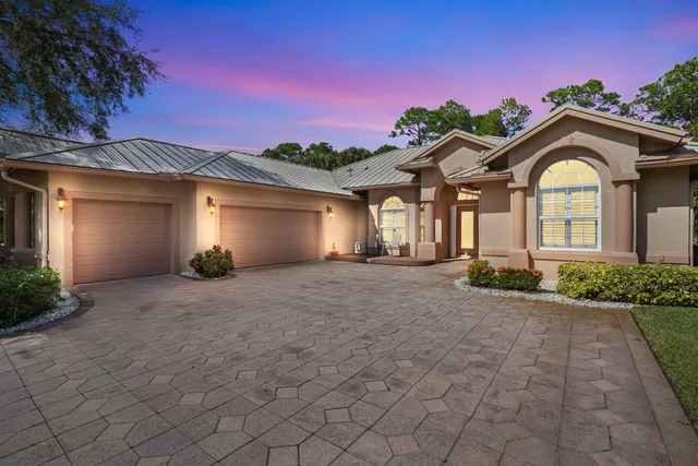 a view of a house with a yard and garage