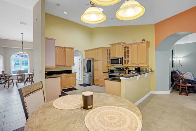 a kitchen with stainless steel appliances a refrigerator sink and stove