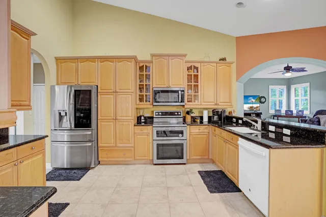 a large kitchen with lots of counter space and furniture