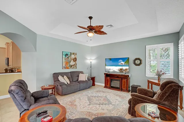 a living room with furniture ceiling fan and a rug