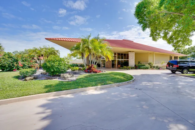 a very nice looking dining room with kitchen island granite countertop a large window and a counter space