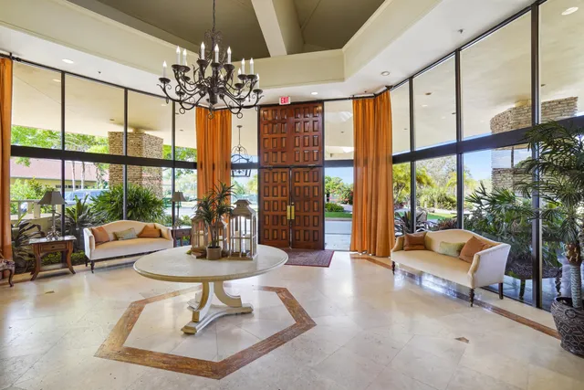 a view of a patio with table and chairs potted plants and a large tree