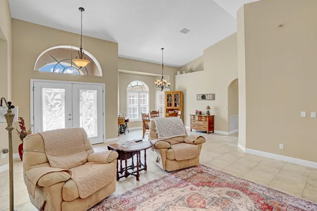 a living room with furniture a flat screen tv and a window
