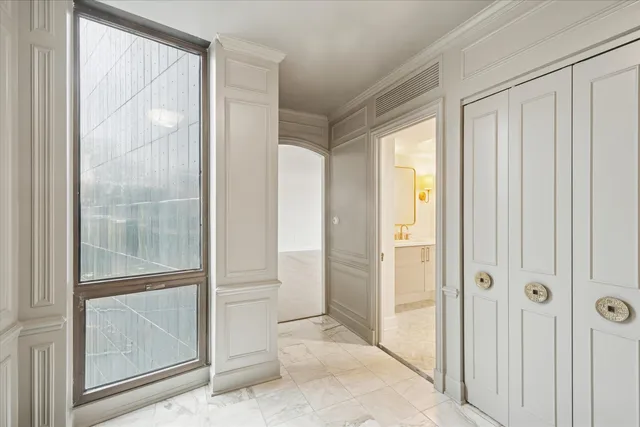 a bathroom with a glass shower door and a glass door
