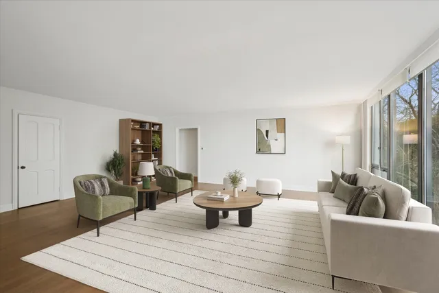 a living room with furniture and a potted plant
