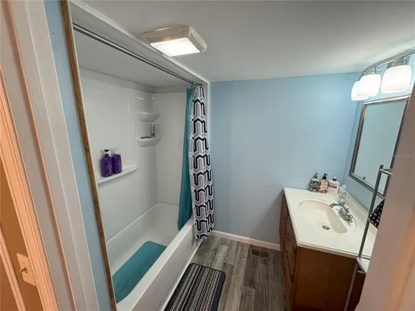 a bathroom with a sink a bath tub and a shower