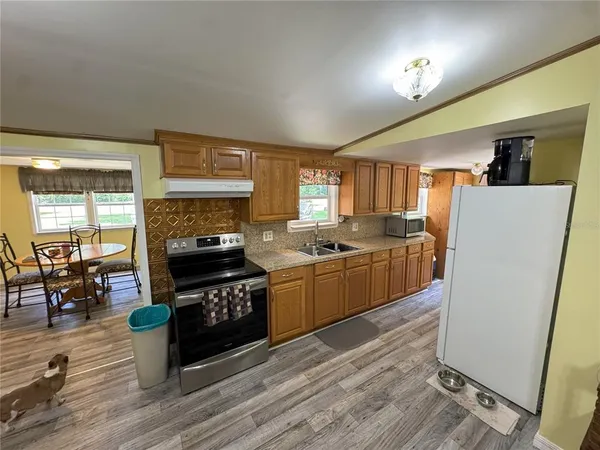 a kitchen with stove cabinets and wooden floor