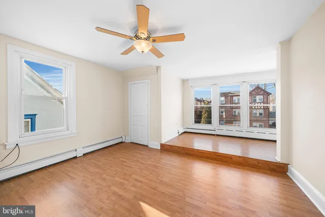 wooden floor in an empty room with a window