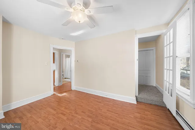 wooden floor in an empty room with a window