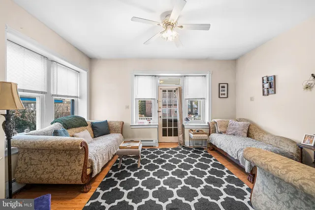 a living room with furniture and a lamp