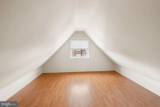 a view of a big room with wooden floor and windows