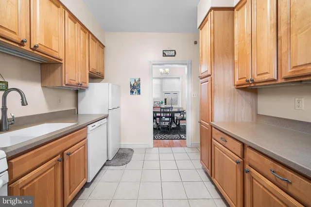 a kitchen with stainless steel appliances a refrigerator and cabinets
