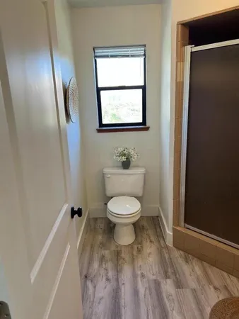 a bathroom with a toilet a sink and mirror