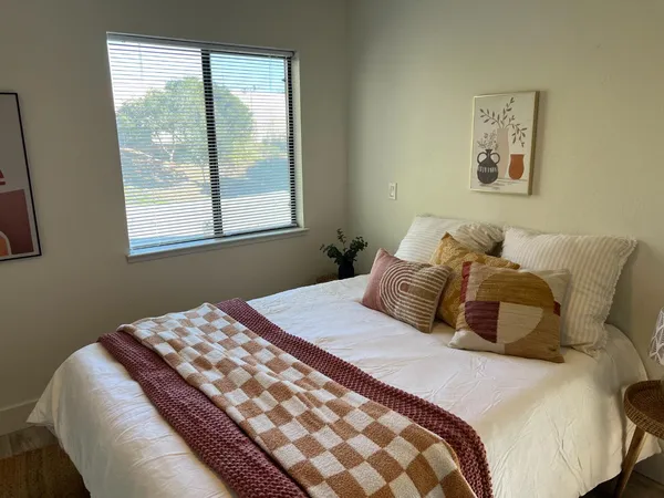 a bedroom with a large bed and a window