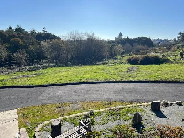 a view of a backyard with swimming pool and outdoor seating