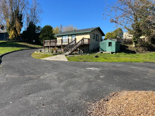 a view of house with outdoor space and parking