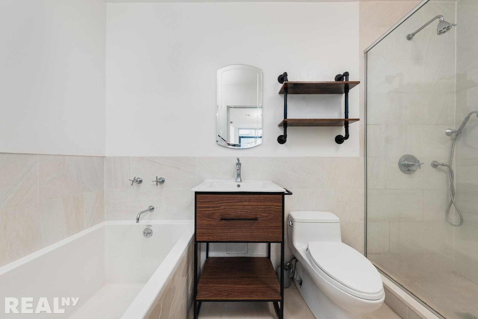 82 Guernsey Street, Unit PH5 Brooklyn, NY 11222 - Photo 6 of 10 a bathroom with a sink a toilet and a bathtub