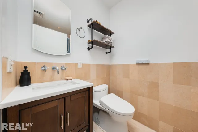 a bathroom with a sink a toilet and mirror