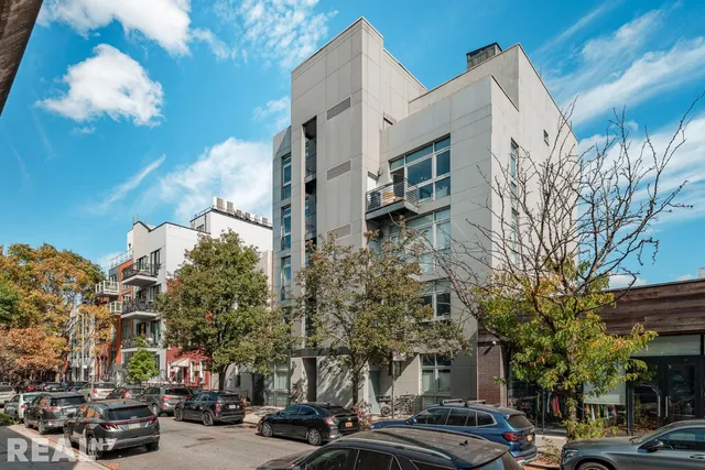 a city street lined with buildings and cars