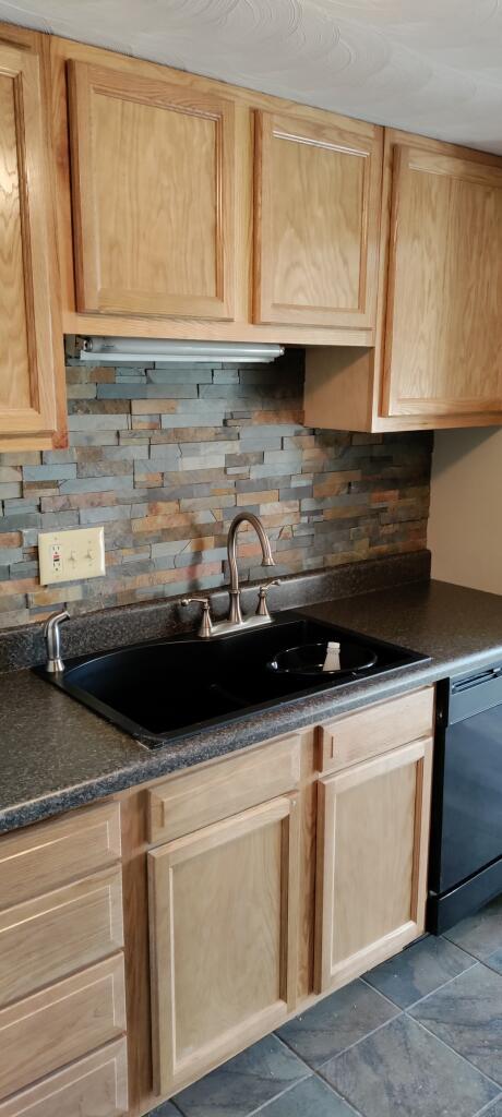 2317 Ranch Road Northwest Roanoke, VA 24017 - Photo 2 of 10 a kitchen with granite countertop a sink and a stove