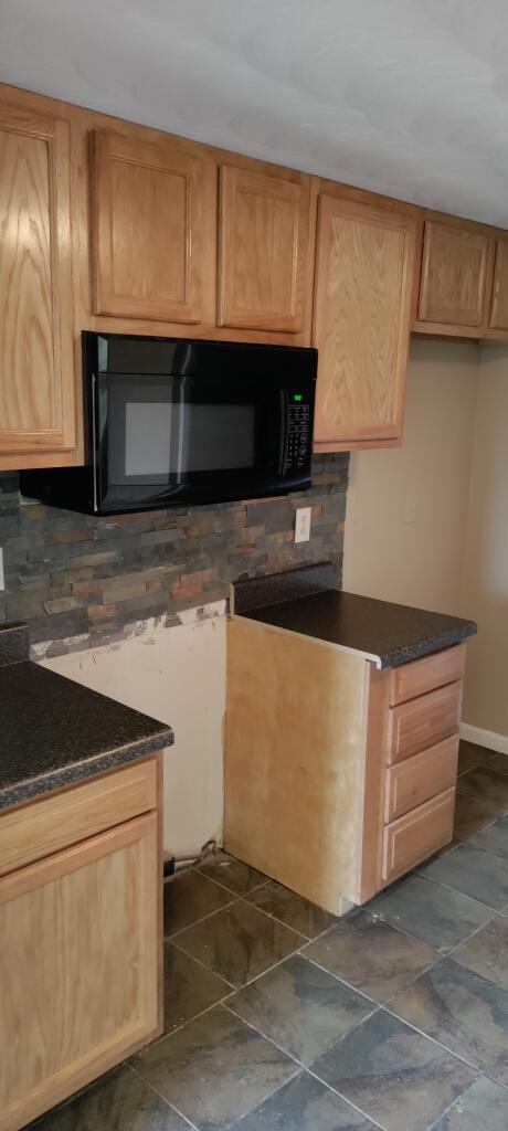 2317 Ranch Road Northwest Roanoke, VA 24017 - Photo 3 of 10 a kitchen with granite countertop white cabinets and stainless steel appliances
