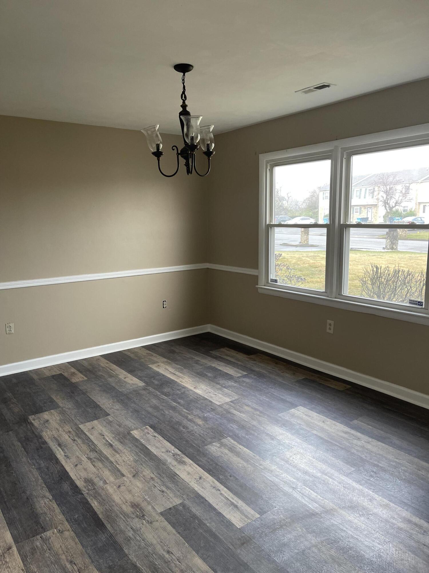 2317 Ranch Road Northwest Roanoke, VA 24017 - Photo 8 of 10 wooden floor in an empty room with a window