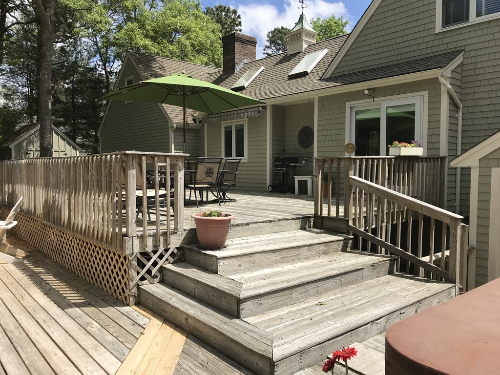 61 Whitmar Road Barnstable, MA 02635 - Photo 19 of 25 a view of a patio with a table and chairs