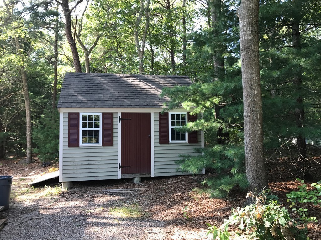 61 Whitmar Road Barnstable, MA 02635 - Photo 21 of 25 a view of a house with a yard and large tree