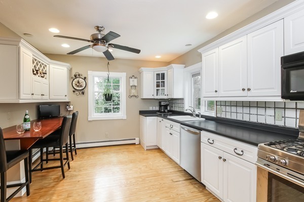 61 Whitmar Road Barnstable, MA 02635 - Photo 9 of 25 a kitchen with stainless steel appliances granite countertop a stove a sink dishwasher and a refrigerator with wooden floor