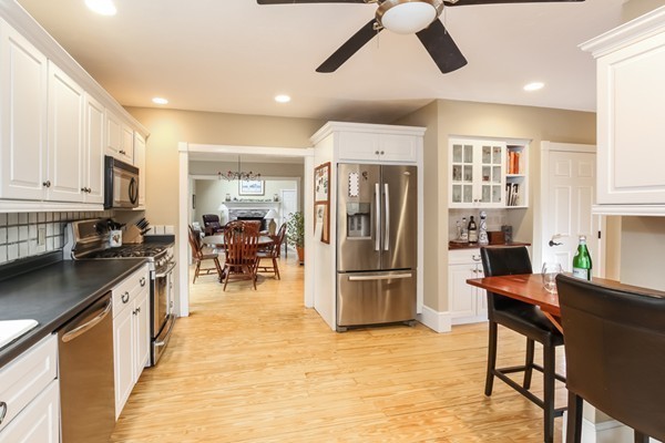61 Whitmar Road Barnstable, MA 02635 - Photo 10 of 25 a kitchen with stainless steel appliances kitchen island granite countertop a refrigerator and a stove top oven