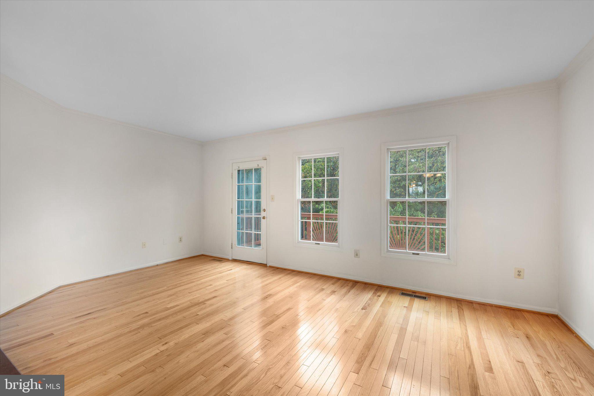 7849 Sabre Court Manassas, VA 20109 - Photo 11 of 35 an empty room with wooden floor and windows