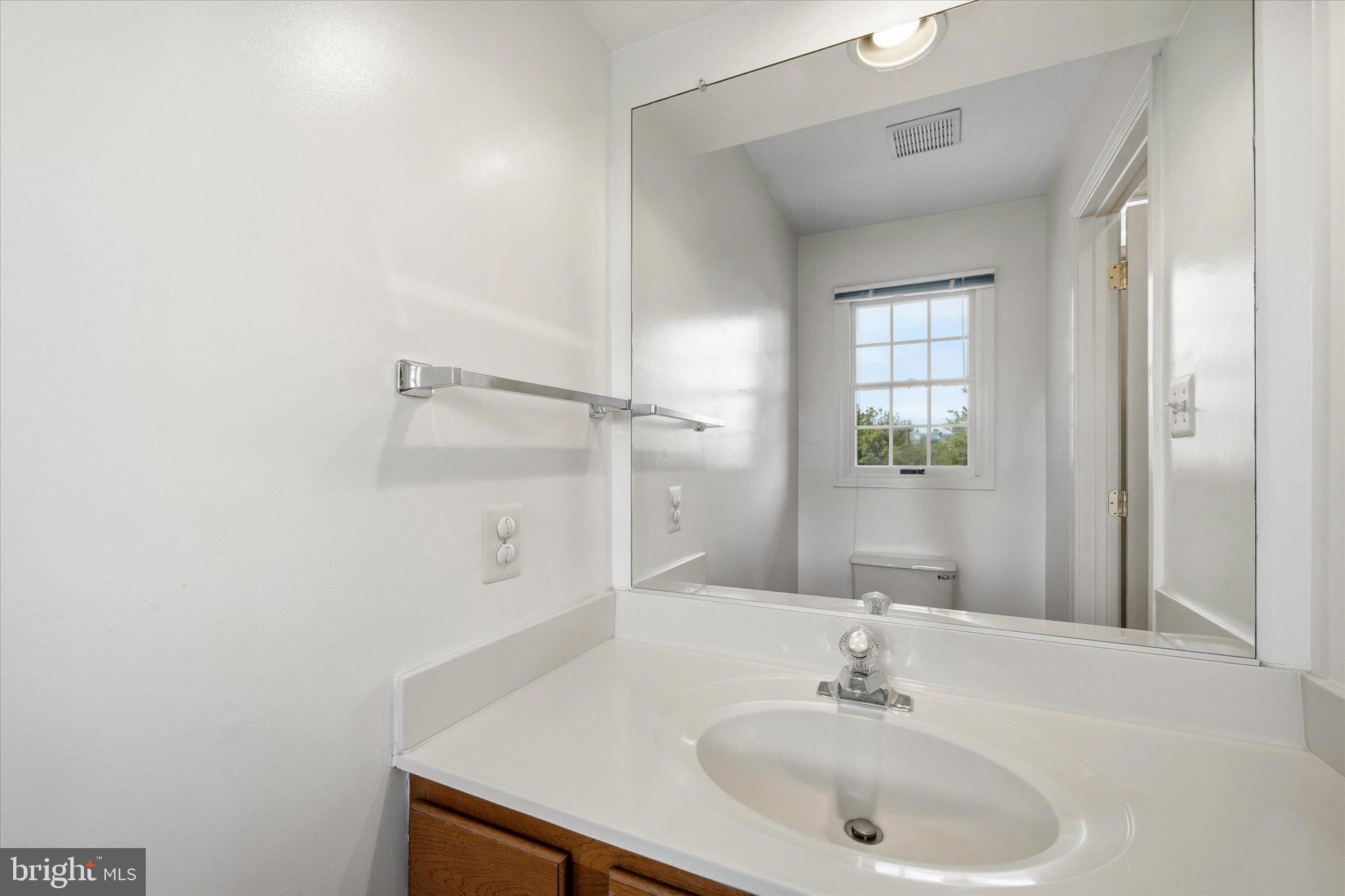 7849 Sabre Court Manassas, VA 20109 - Photo 14 of 35 a bathroom with a sink and a mirror