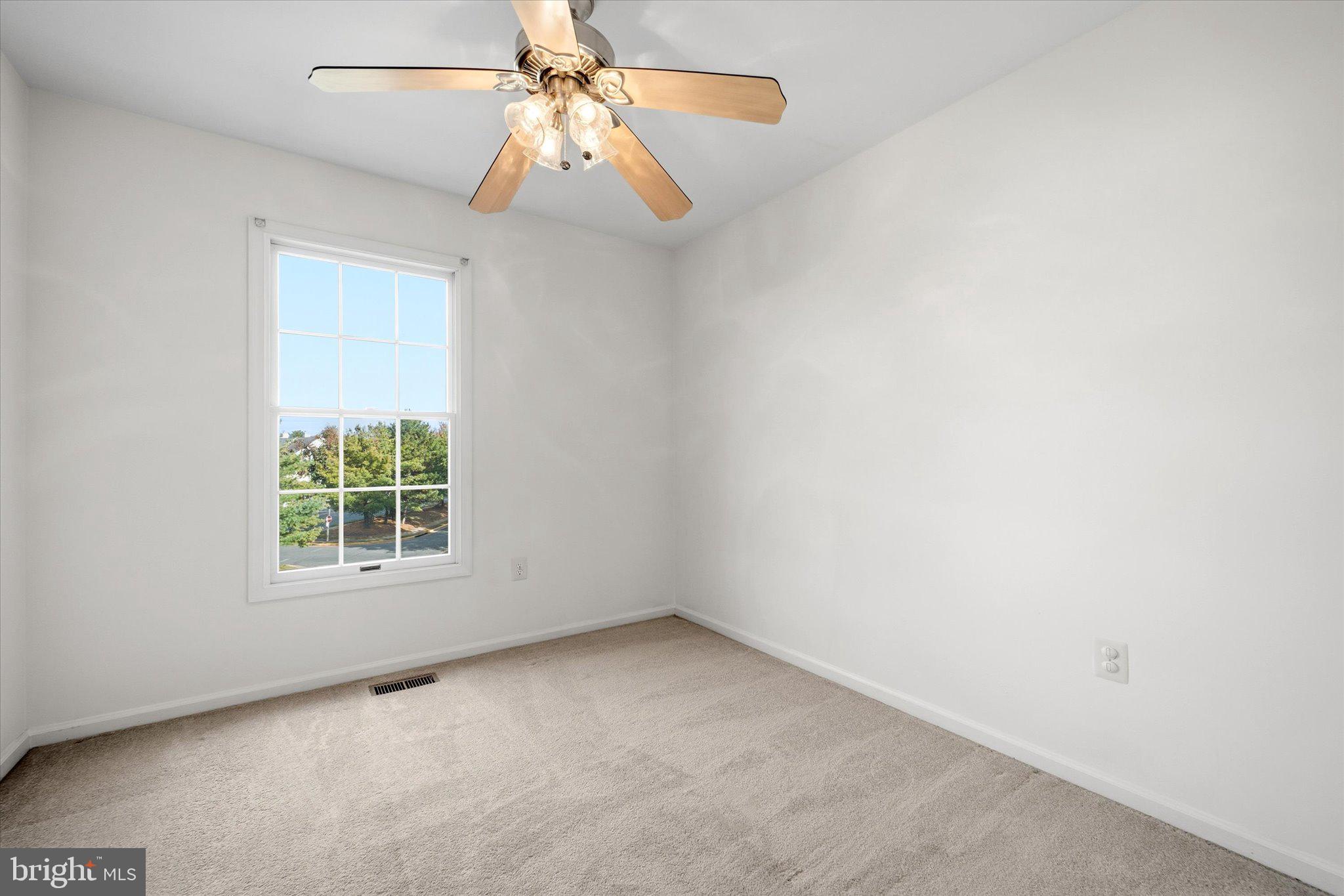 7849 Sabre Court Manassas, VA 20109 - Photo 21 of 35 an empty room with a window and a fan