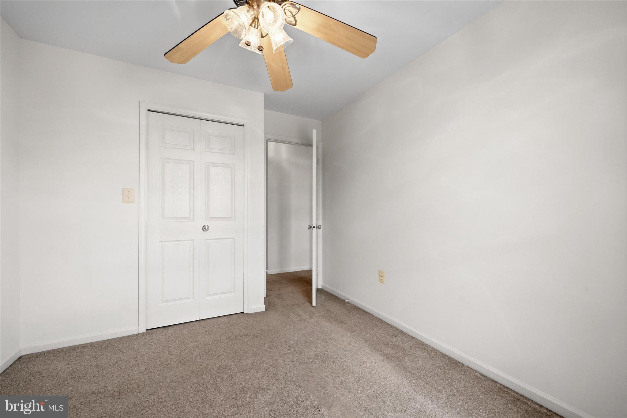 7849 Sabre Court Manassas, VA 20109 - Photo 22 of 35 an empty room with a chandelier fan and table