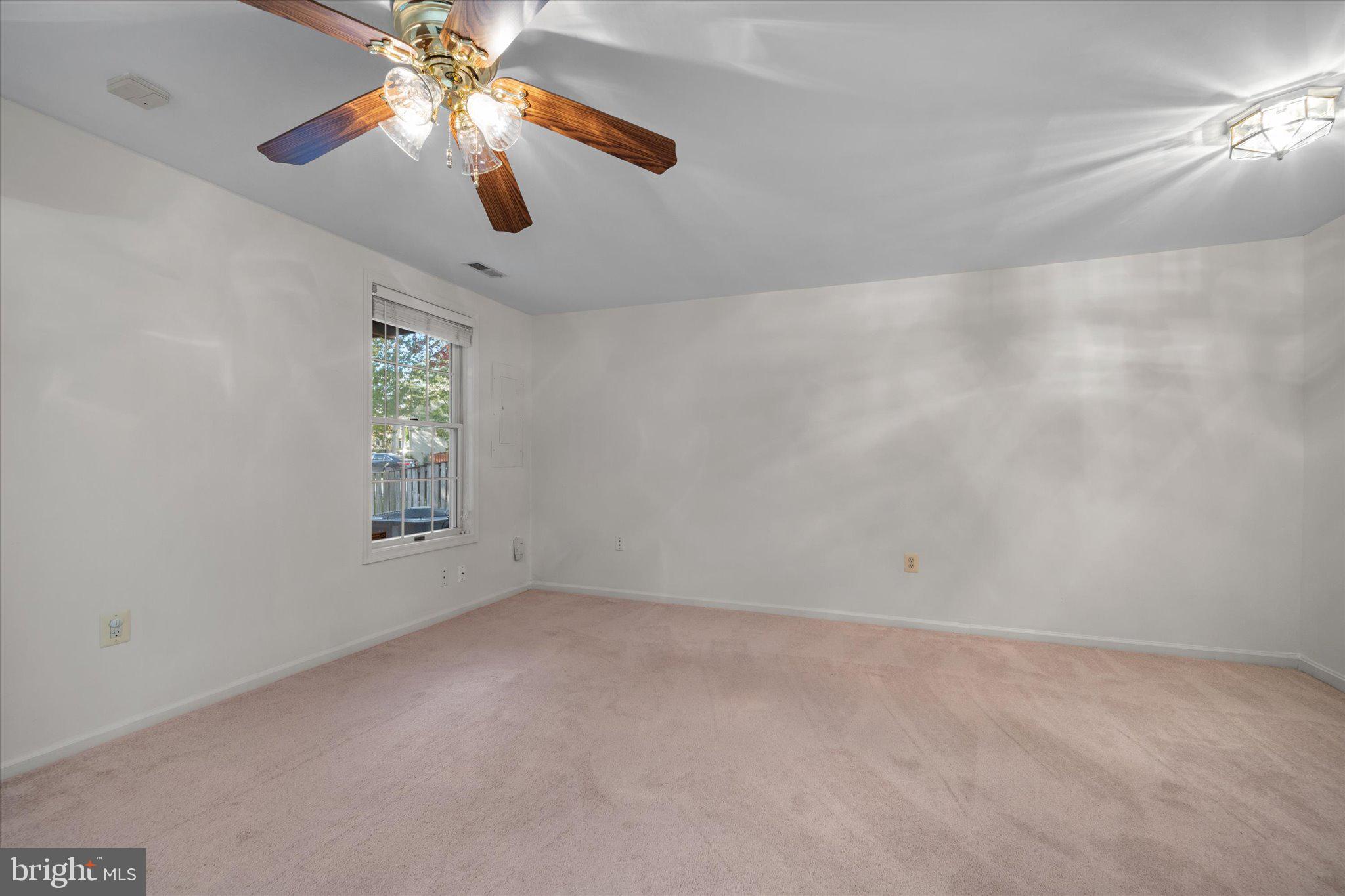 7849 Sabre Court Manassas, VA 20109 - Photo 29 of 35 en empty room with windows and chandelier fan