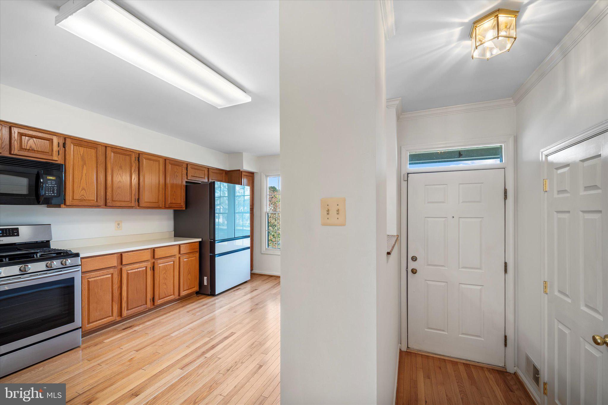 7849 Sabre Court Manassas, VA 20109 - Photo 4 of 35 a kitchen with stainless steel appliances granite countertop a refrigerator and a stove top oven
