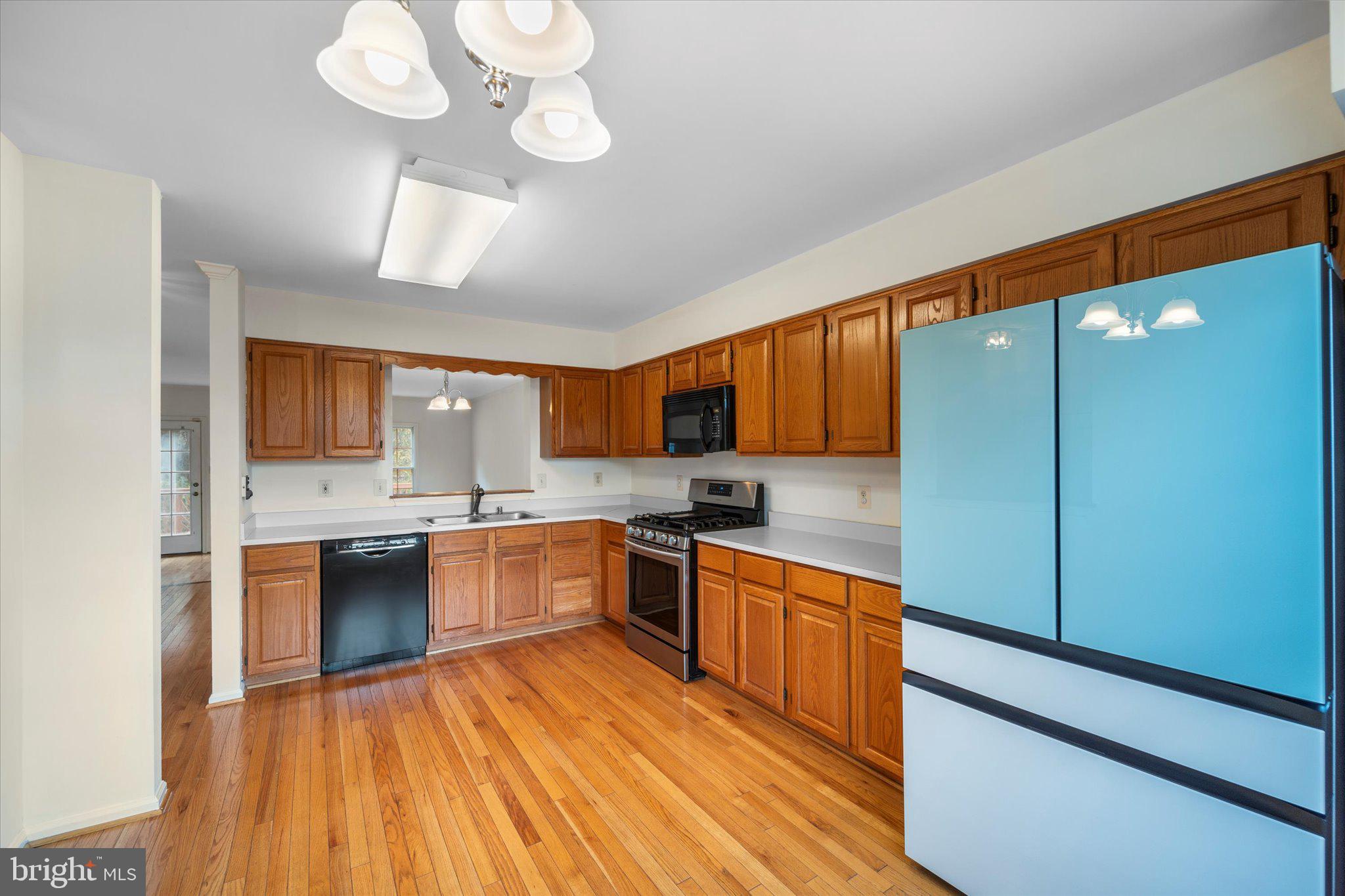 7849 Sabre Court Manassas, VA 20109 - Photo 8 of 35 a large kitchen with stainless steel appliances granite countertop a stove refrigerator and cabinets