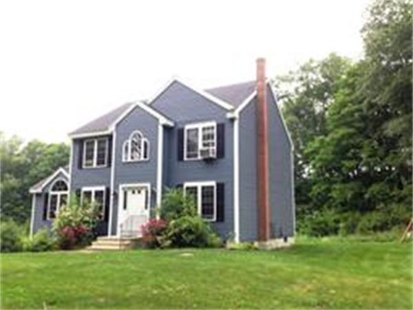 174 Northwest Road Spencer, MA 01562 - Photo 1 of 10 a front view of a house with a yard and trees