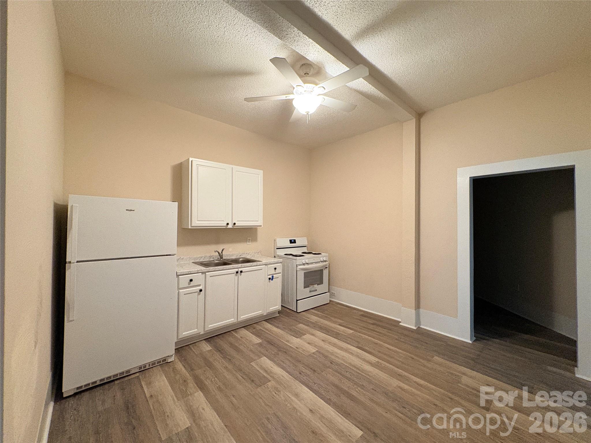 1109 6th Street, Unit B Lancaster, SC 29720 - Photo 10 of 22 a kitchen with a refrigerator and a stove