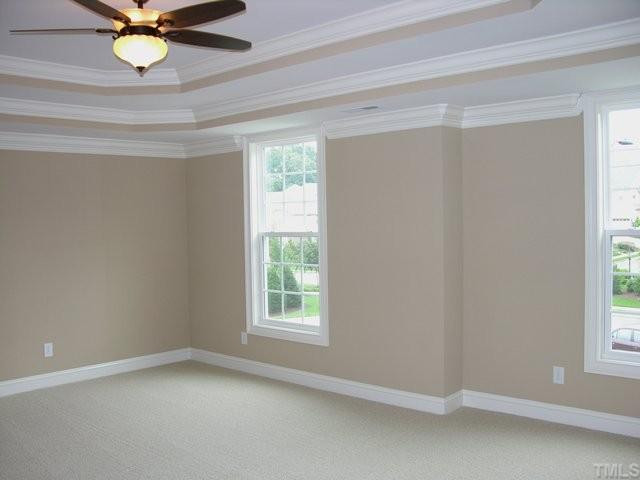 3903 Morvan Way Raleigh, NC 27612 - Photo 8 of 12 2nd floor Master Suite is oversized for sitting area. Large trey ceiling and crown moulding. Home sits back from the street. Master is located at the front of the home and views the European inspired community. Glamour bath is to the left. Master Suite